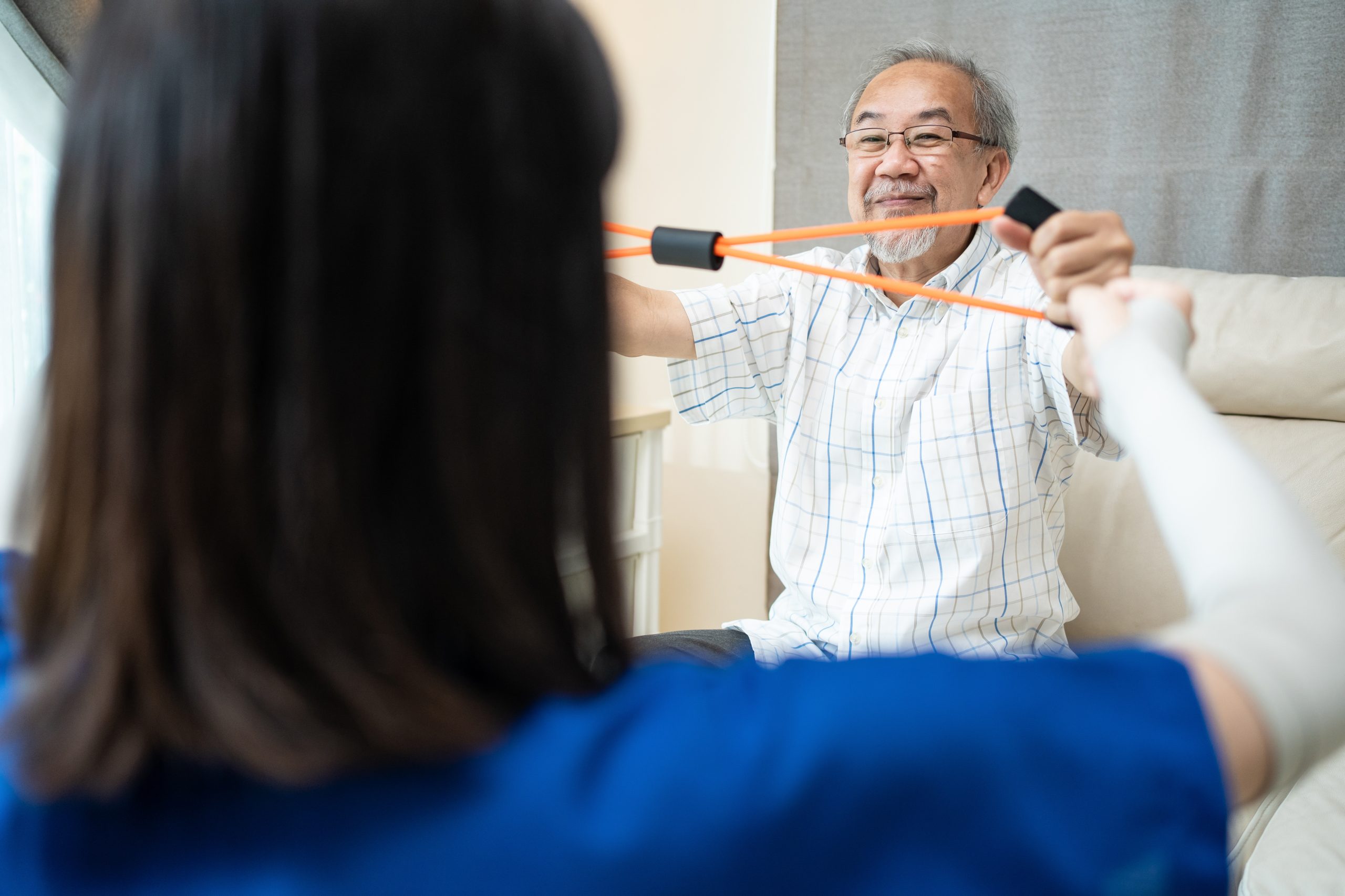 asian-disabled-senior-older-man-sitting-on-sofa-do-2023-11-27-05-35-49-utc
