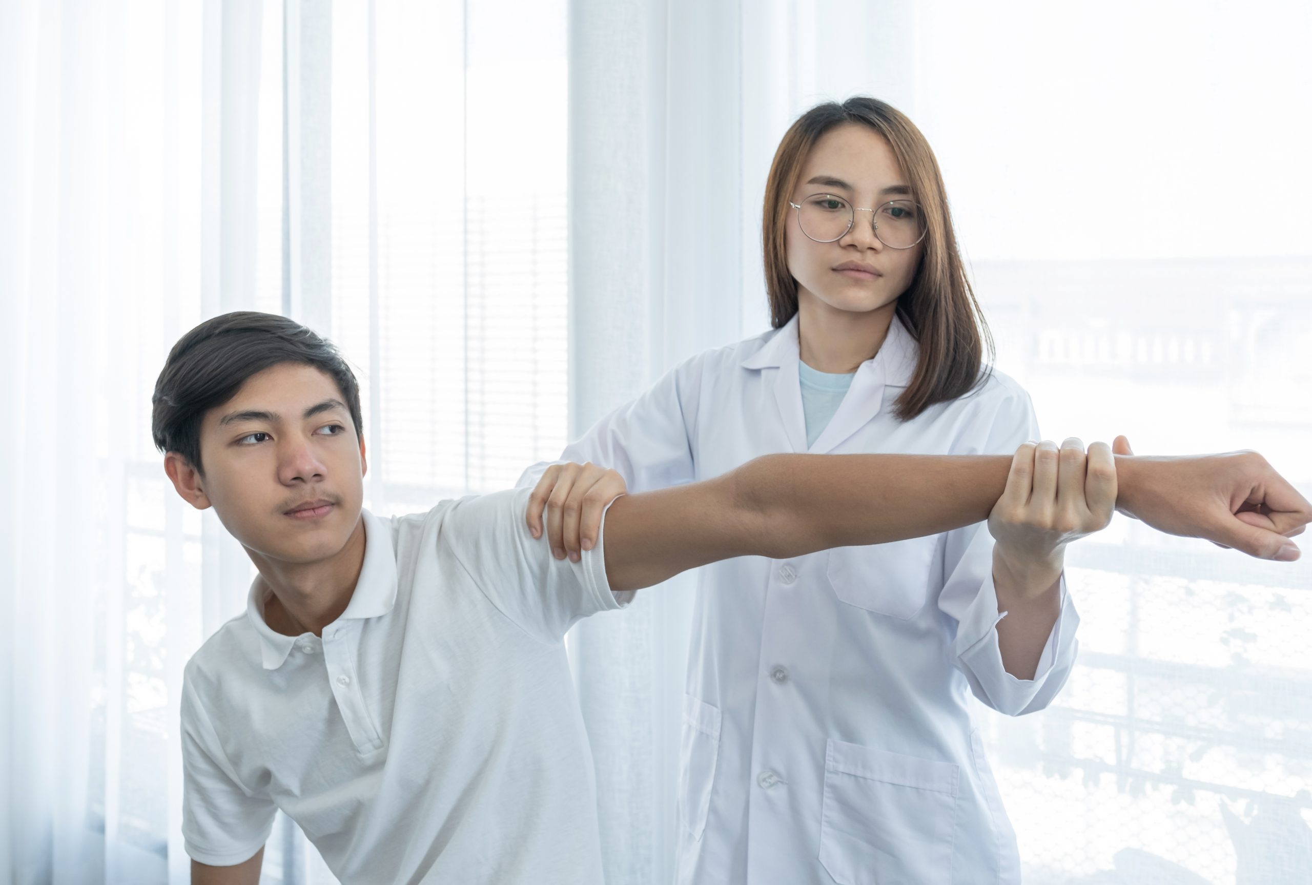 Female doctor doing physical therapy By extending the hand of a